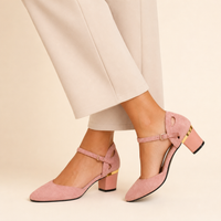 Model wearing dusty pink buckle block-heel pumps